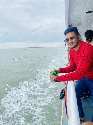 Relaxing on a boat and feeding seagulls near the shore of Coxs Bazar