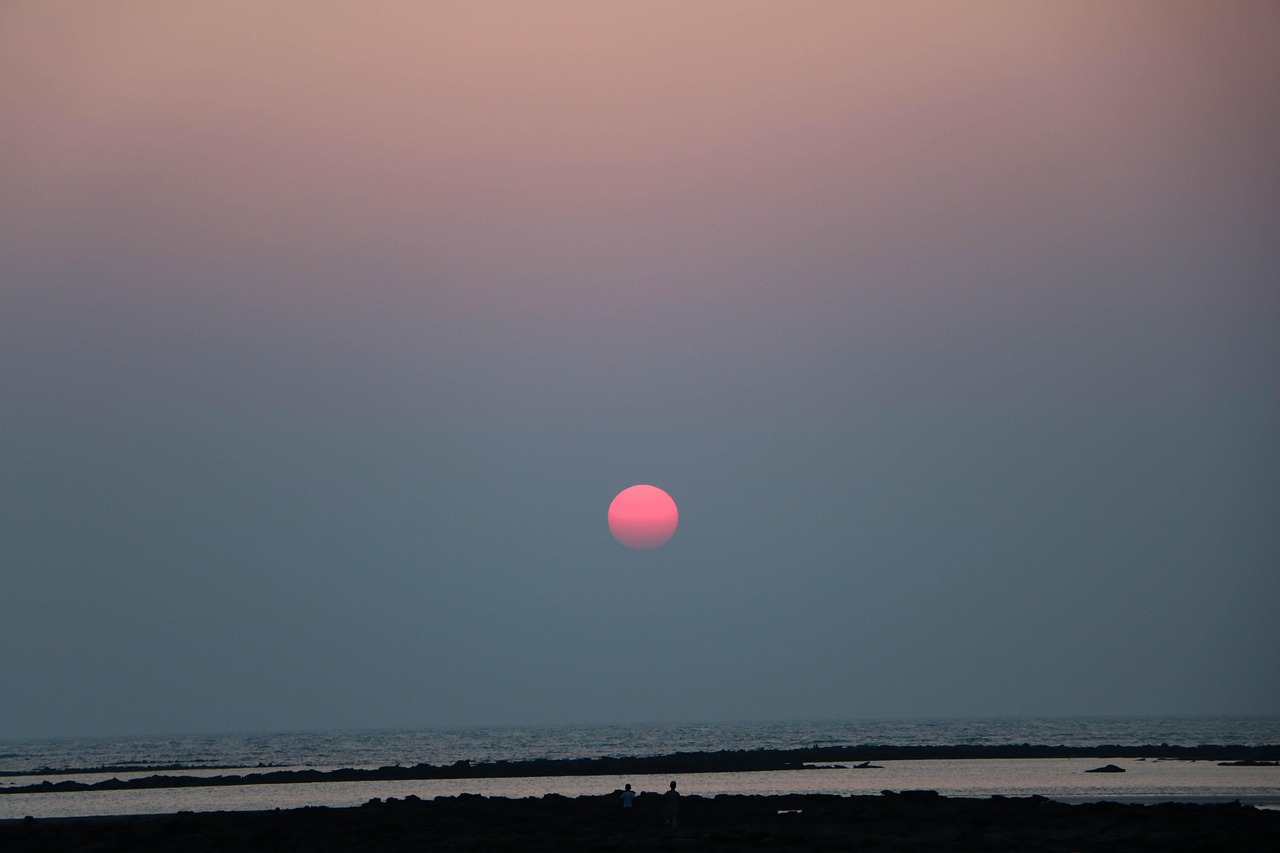 Golden sunset view at Saint Martin Island showing beach, sea, and fishing boats